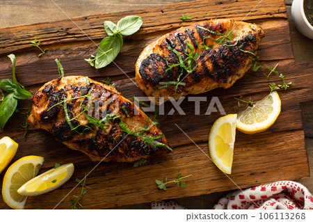 Balsamic grilled chicken breast on a board 106113268