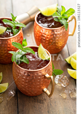 Traditional Moscow Mule in classic copper mugs Traditional Moscow Mule in classic copper mugs 106113327