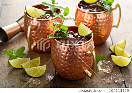 Traditional Moscow Mule in classic copper mugs Traditional Moscow Mule in classic copper mugs 106113329