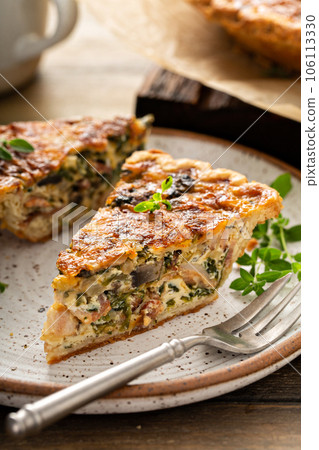 Bacon, mushroom and spinach quiche with cheese and herbs Bacon, mushroom and spinach quiche with cheese and herbs 106113330
