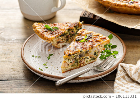 Bacon, mushroom and spinach quiche with cheese and herbs Bacon, mushroom and spinach quiche with cheese and herbs 106113331