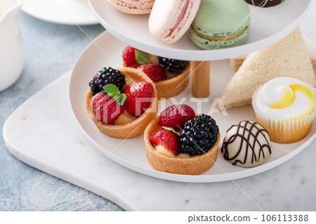 Spring or summer dessert table, three tiered tray with desserts Spring or summer dessert table, three tiered tray with desserts 106113388