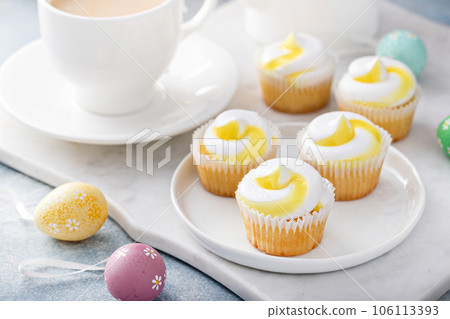 Lemon cupcakes for Easter on a white plate 106113393