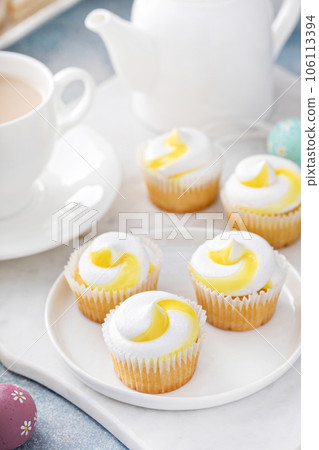 Lemon cupcakes for Easter on a white plate 106113394