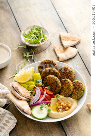 Baked falafel bowl with hummus and vegetables Baked falafel bowl with hummus and vegetables 106113405