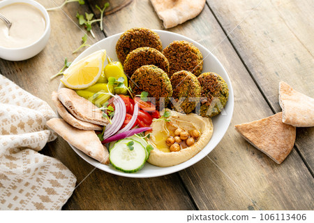 Baked falafel bowl with hummus and vegetables 106113406