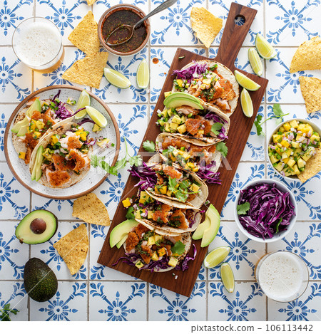 Fish tacos with mango salsa and red cabbage Fish tacos with mango salsa and red cabbage 106113442