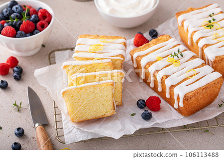 Classic vanilla pound cake with powdered sugar glaze sliced on parchment Classic vanilla pound cake with powdered sugar glaze sliced on parchment 106113488