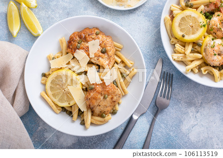 Chicken piccatta with penne pasta, lemon and capers 106113519