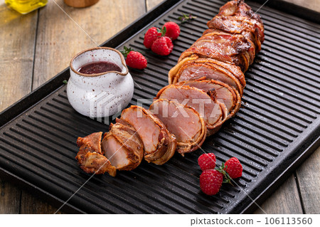 Bacon wrapped pork tenderloin with raspberry vinaigrette Bacon wrapped pork tenderloin with raspberry vinaigrette 106113560
