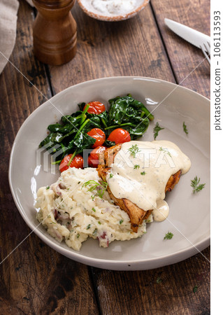 Roasted chicken thighs served with creamy sauce and mashed potatoes Roasted chicken thighs served with creamy sauce and mashed potatoes 106113593