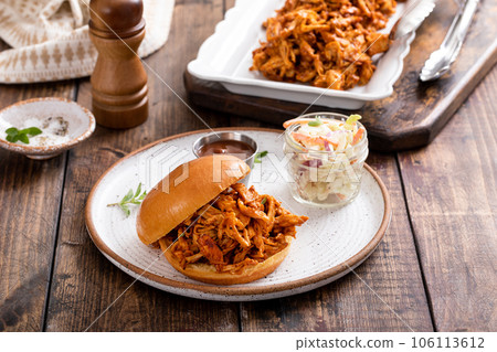 BBQ chicken sandwich on a brioche bun with coleslaw BBQ chicken sandwich on a brioche bun with coleslaw 106113612