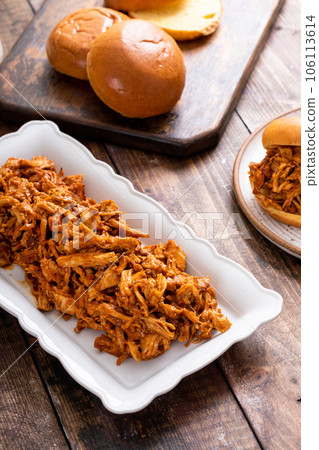 Pulled bbq chicken on a serving plate 106113614