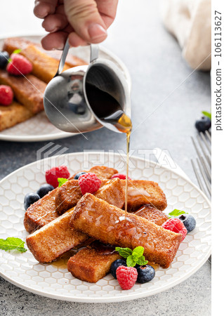 French toast sticks with maple syrup and berries 106113627