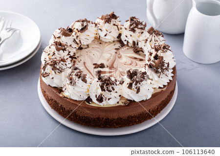 Chocolate cheesecake with whipped cream and chocolate shavings 106113640