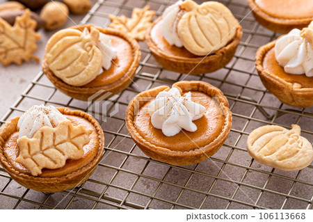 Mini pumpkin pies with wipped cream and cinnamon Mini pumpkin pies with wipped cream and cinnamon 106113668
