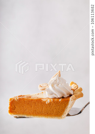 Pumpkin cheesecake swirl pie topped with whipped cream 106113682