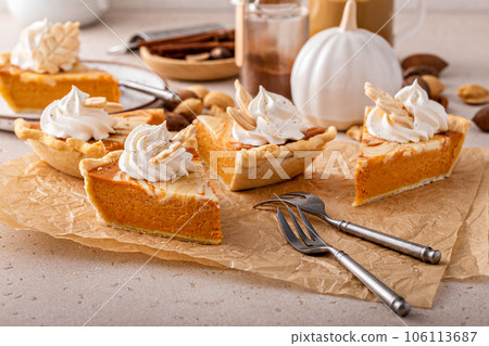 Pumpkin cheesecake swirl pie topped with whipped cream 106113687