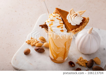 Pumpkin pie milkshake with caramel syrup and whipped cream 106113704