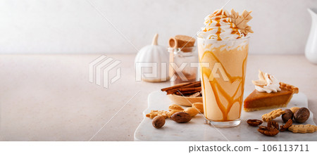 Pumpkin pie milkshake with caramel syrup and whipped cream Pumpkin pie milkshake with caramel syrup and whipped cream 106113711
