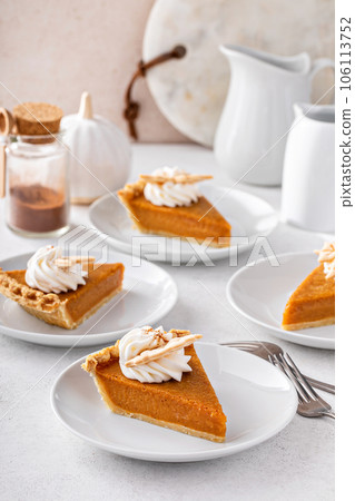 Slices of traditional pumpkin pie in a light and bright setting 106113752