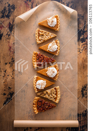 Traditional fall Thanksgiving pie slices, pumpkin and pecan pie Traditional fall Thanksgiving pie slices, pumpkin and pecan pie 106113765