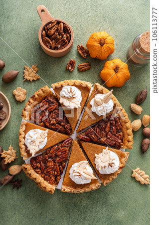 Traditional fall Thanksgiving pie slices, pumpkin and pecan pie Traditional fall Thanksgiving pie slices, pumpkin and pecan pie 106113777