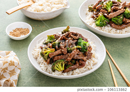 Beef and broccoli stir fry served over rice 106113862
