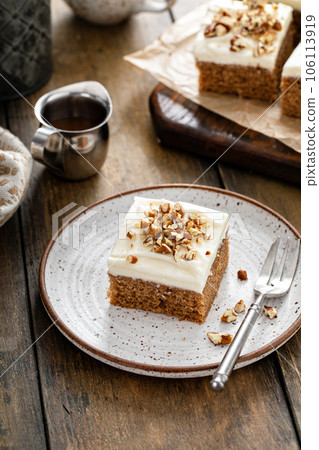 Carrot or pumpkin spiced cake with cream cheese frosting and pecan 106113919