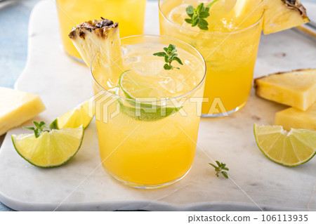 Pineapple and lime cocktail, margarita in small glasses Pineapple and lime cocktail, margarita in small glasses 106113935