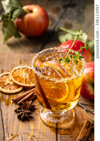 Festive fall cocktail or mocktail with hard cider, apple and orange 106113997