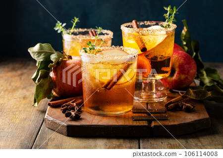 Apple cider margarita with brown sugar rim and cinnamon stick 106114008