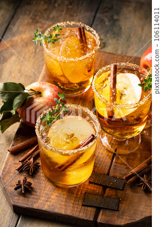 Apple cider margarita with brown sugar rim and cinnamon stick Apple cider margarita with brown sugar rim and cinnamon stick 106114011