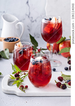 Fall berry and apple sangria in a glass with ice 106114048