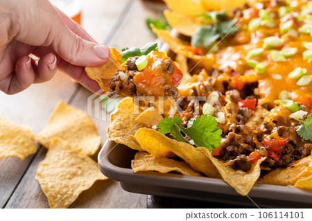 Traditional nachos with ground beef and red pepper Traditional nachos with ground beef and red pepper 106114101