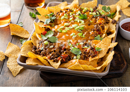 Traditional nachos with ground beef and red pepper 106114103