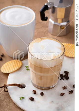 Hot coffee latte and cappuchino in a glass and mug 106114125
