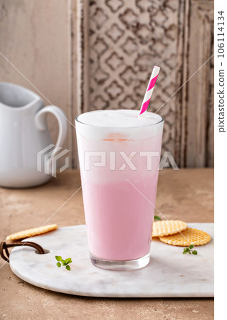 Strawberry or raspberry iced milk cocktail in a tall glass Strawberry or raspberry iced milk cocktail in a tall glass 106114134