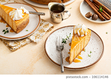 Pumpkin cheesecake with fall spices topped with whipped cream 106114146