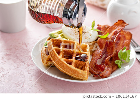 Crispy Belgian waffles with avocado and bacon for breakfast 106114167