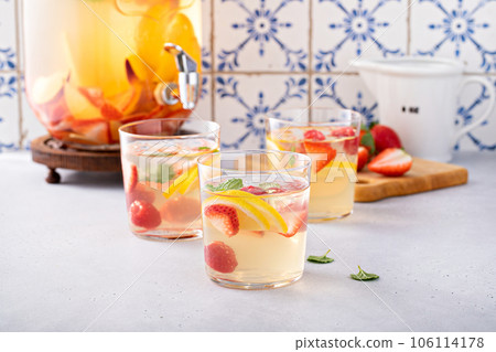 Summer sangria punch in a pitcher and glasses Summer sangria punch in a pitcher and glasses 106114178