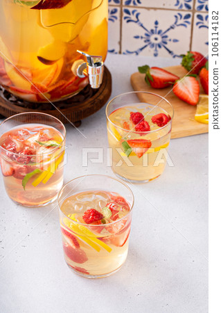 Summer sangria punch in a pitcher and glasses Summer sangria punch in a pitcher and glasses 106114182