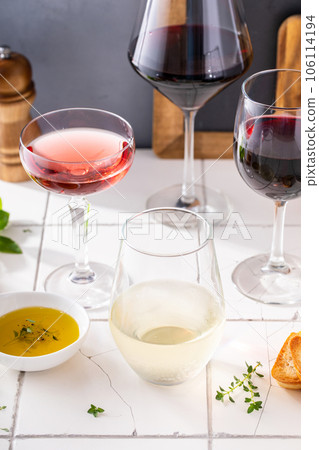Variety of wine glasses with red, white and rose wine 106114194