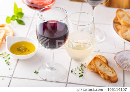 Variety of wine glasses with red, white and rose wine 106114197