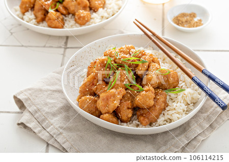 Orange chicken with green onions and sesame seeds 106114215