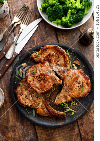 Grilled or pan fried pork chops on the bone Grilled or pan fried pork chops on the bone 106114325
