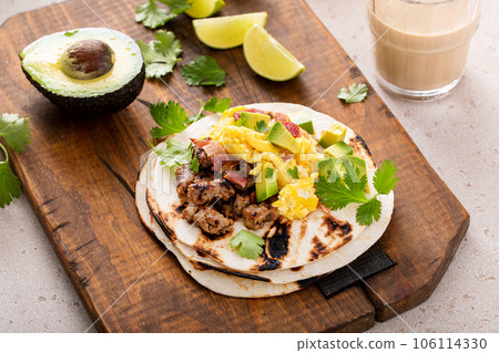 Breakfast tacos with sausage, eggs, bacon and avocado 106114330