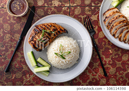 Grilled teriyaki chicken breast with rice and fresh cucumber Grilled teriyaki chicken breast with rice and fresh cucumber 106114398