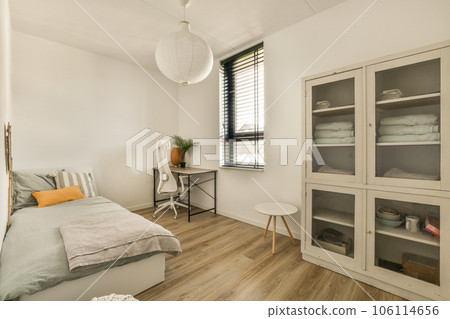 a bedroom with white walls and wood flooring the room is clean and ready to be used for bedding 106114656