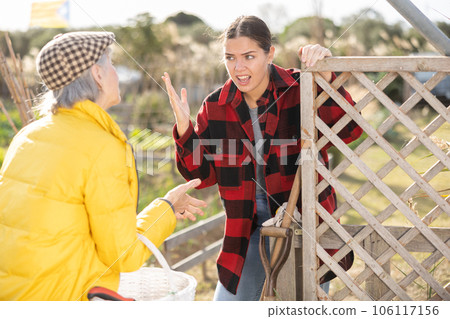 Farm neighbors quarrel over farm backyard in day Farm neighbors quarrel over farm backyard in day 106117156
